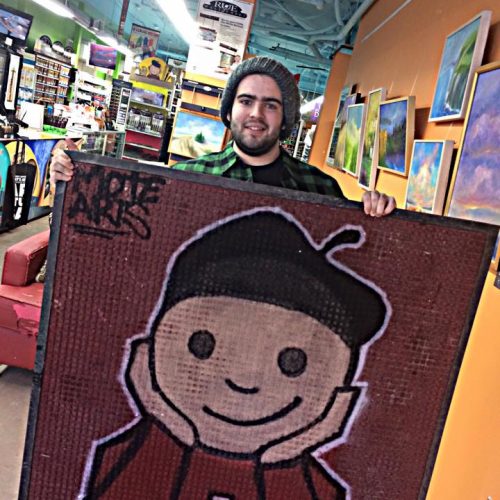 An Artist Shows off His Painting at Jerry's Artarama Art Supply Store of Wilmington, DE
