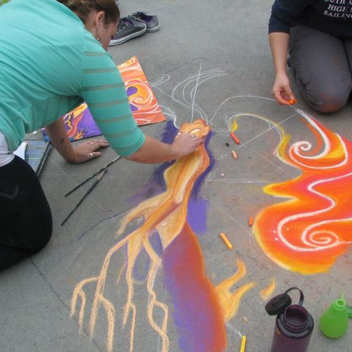 An Artist Drawing with Sidewalk Chalk at Jerry's Artarama of Providence, RI